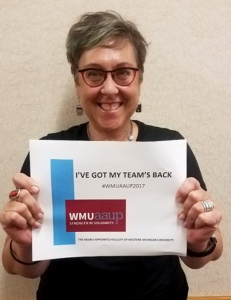 photo of Carol Weideman holding WMU-AAUP solidarity sign